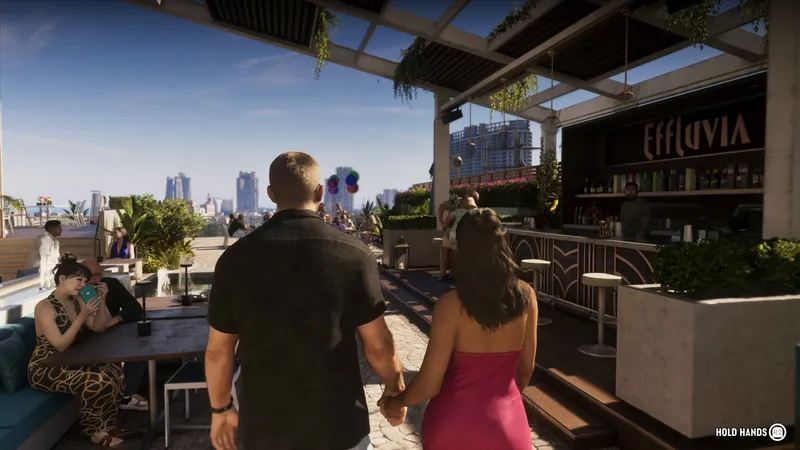 A man and a woman in a pink dress walk hand in hand along a rooftop bar with a skyline behind them