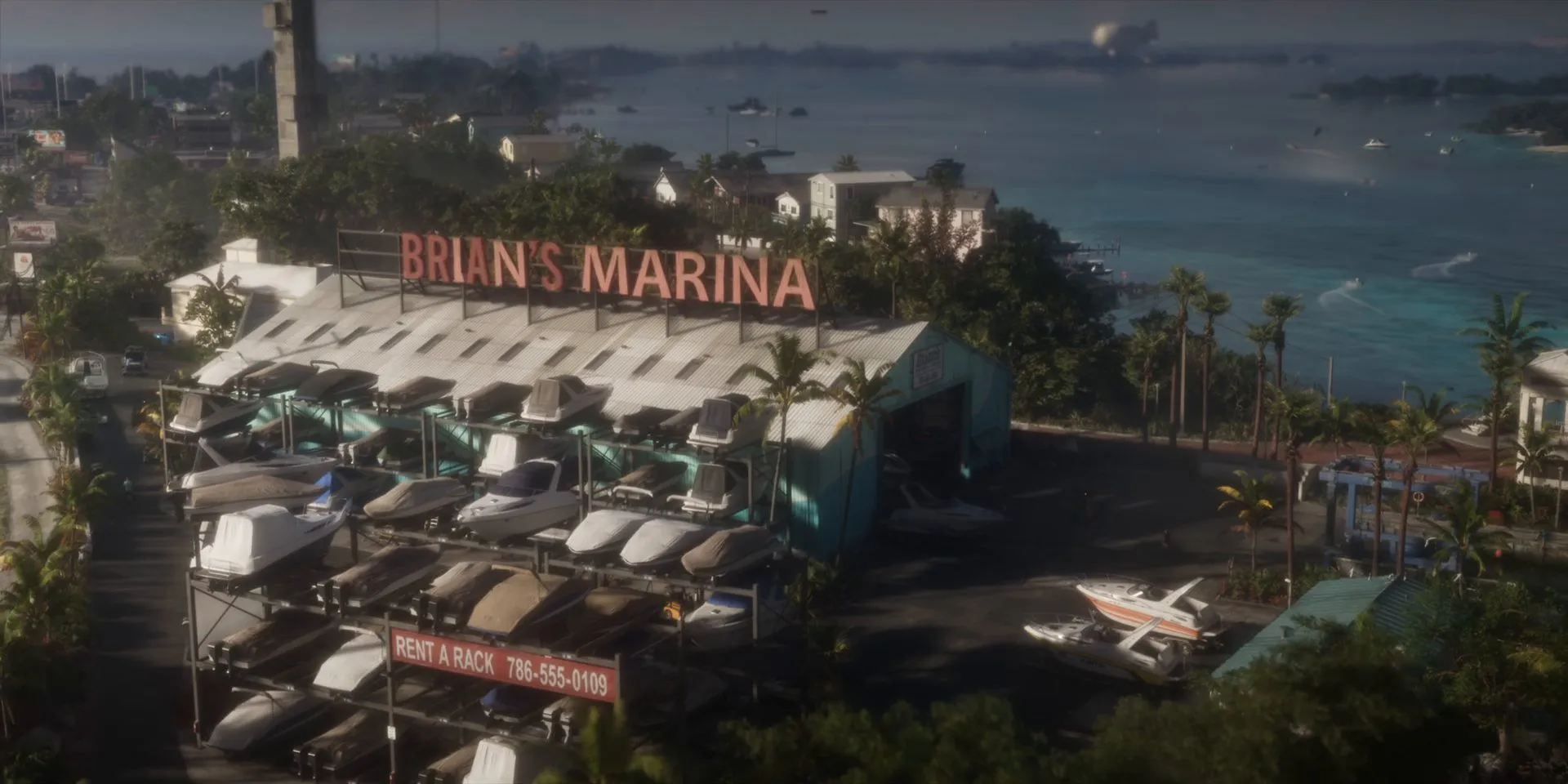 Aerial view of Brian’s Marina with its rooftop sign, racks of stored boats and the bay behind