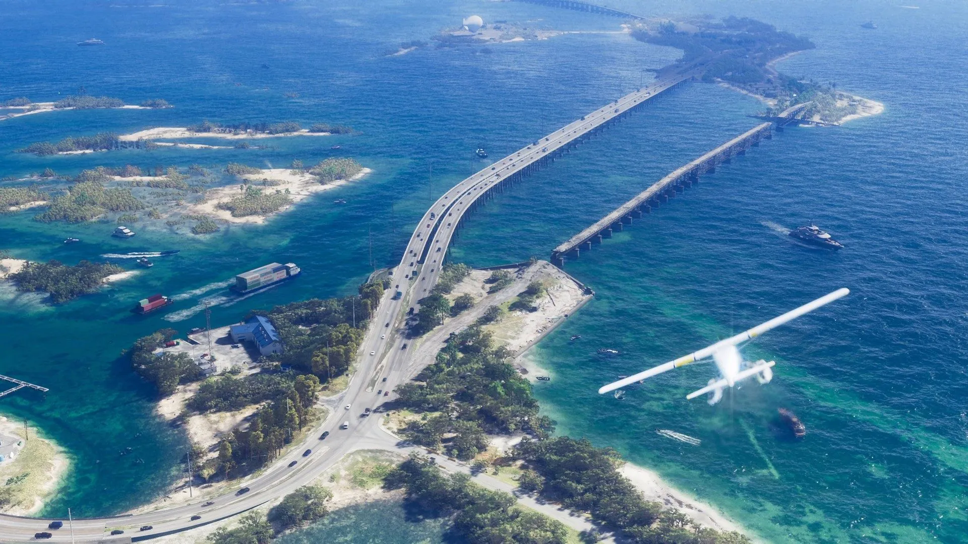 A seaplane flies low over turquoise water beside a bridge across small islands