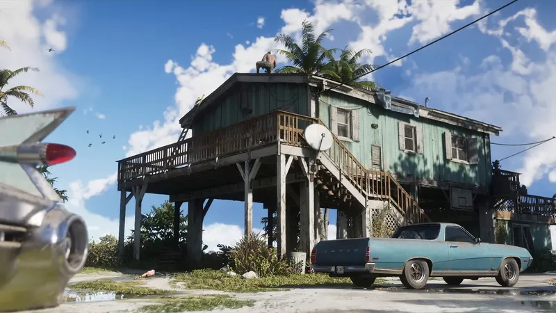 Pale-blue low pickup parked in front of a weathered teal stilt house under a blue sky
