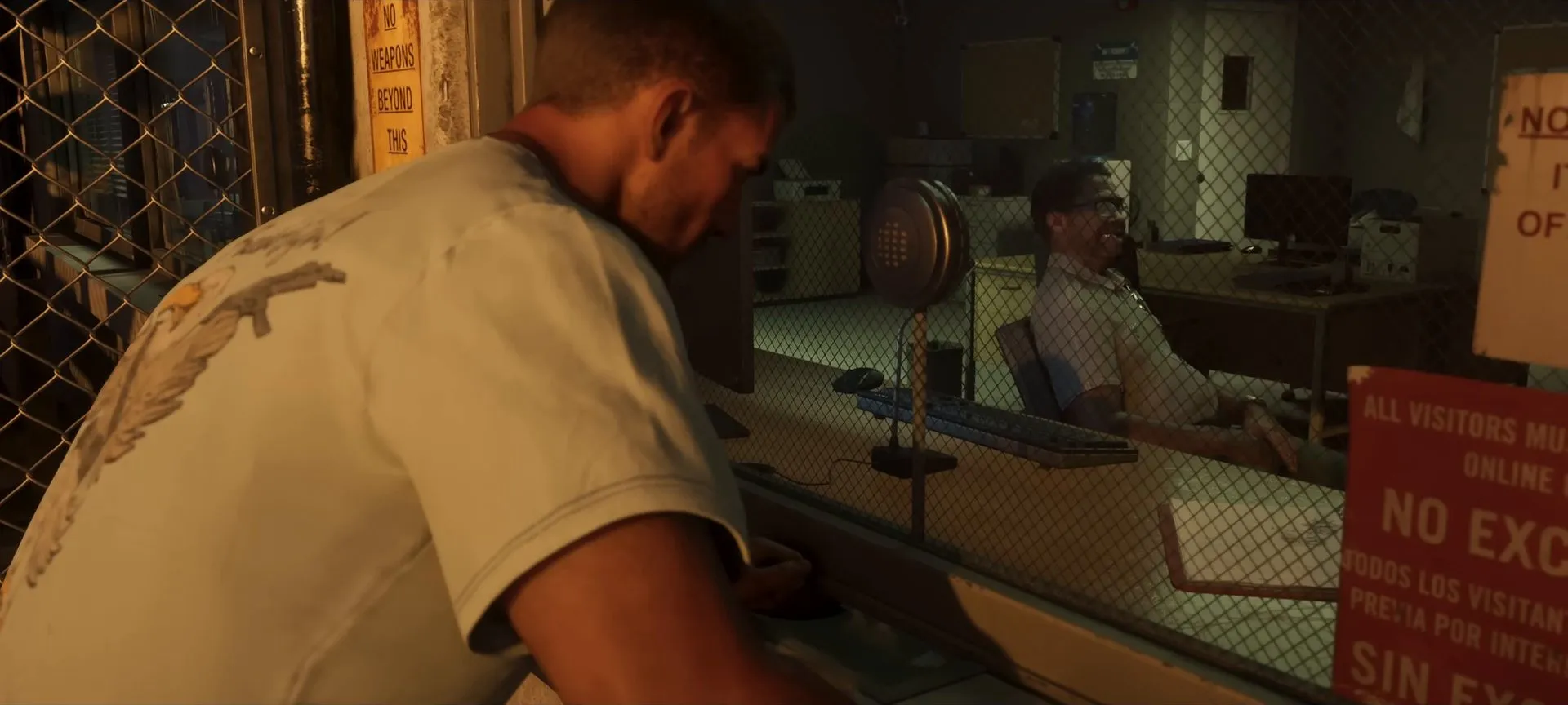 Jason in a white T-shirt at a prison visitor window with an officer behind the glass