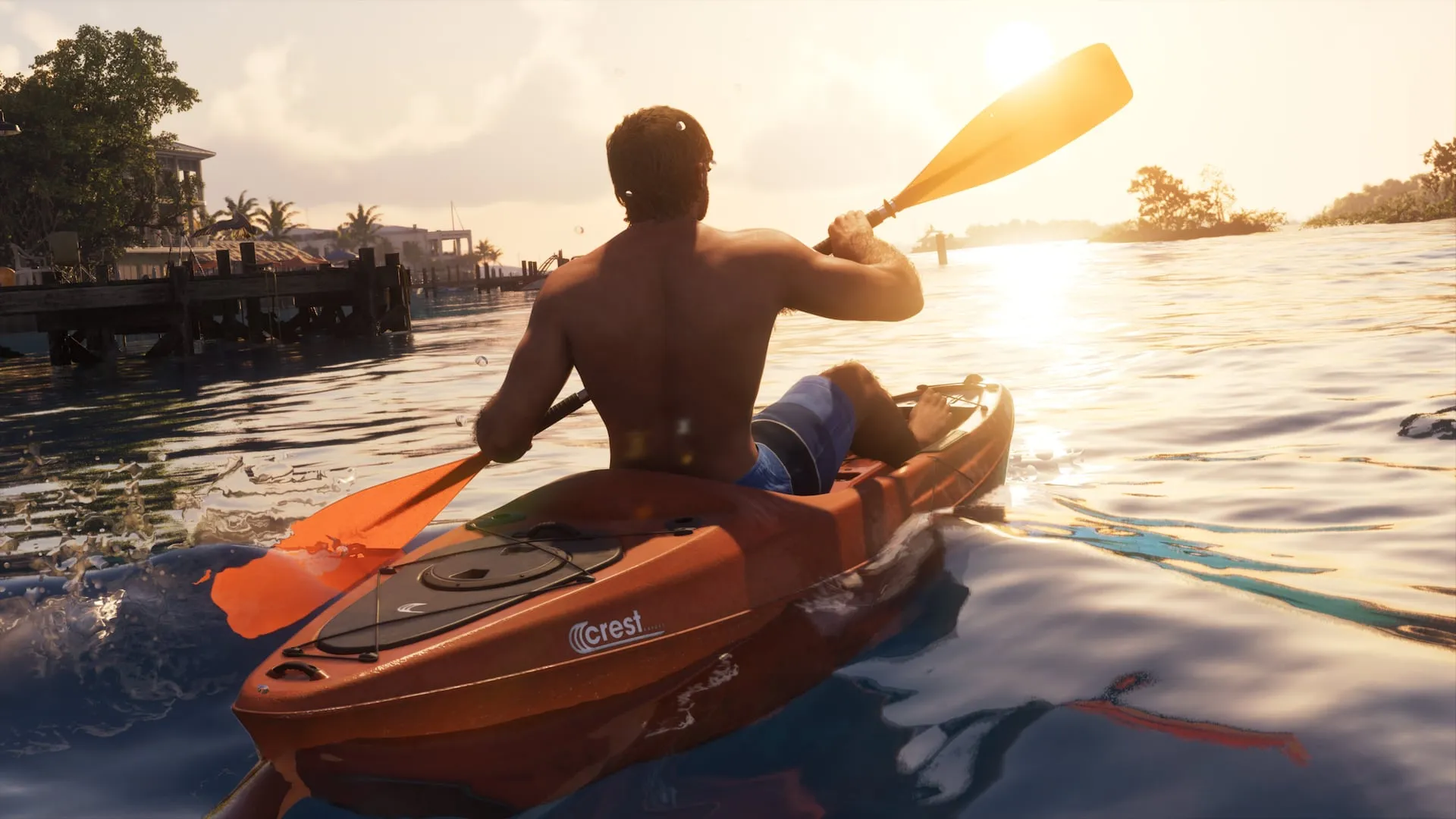 Person paddling a kayak at sunset