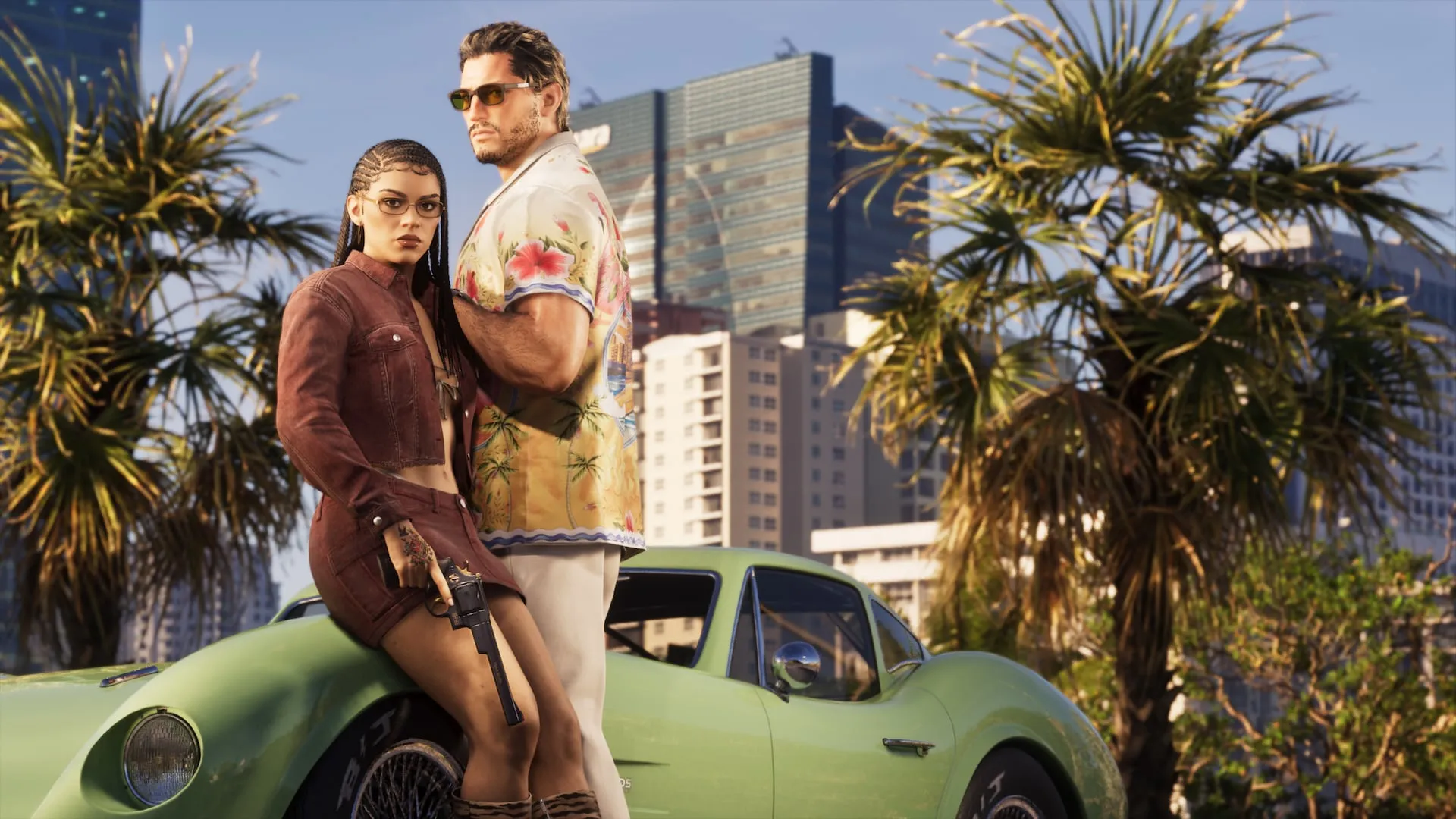 Two people sitting on a green classic car on a palm-lined street
